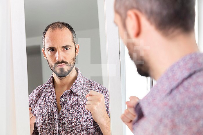 A man looking in a mirror to give him self-confidence.