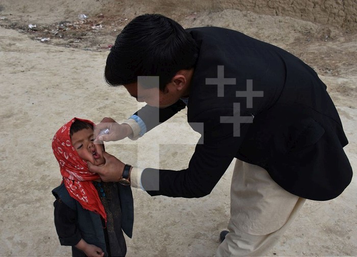 (200310) -- BALKH, March 10, 2020 (Xinhua) -- A health worker gives a polio vaccine to a child in Mazar-i-Sharif, capital of Balkh province, Afghanistan, March 10, 2020. According to local officials, the Afghan Public Health Ministry launched a polio vaccination campaign on Tuesday, targeting some 465,000 children under the age of five in Balkh province. (Photo by Kawa Basharat/Xinhua) Xinhua News Agency / eyevine  Contact eyevine for more information about using this image: T: +44 (0) 20 8709 8709 E: info@eyevine.com http://www.eyevine.com . AFGHANISTAN-BALKH-POLIO VACCINATION