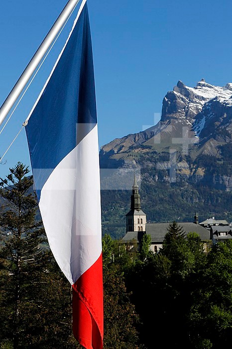 Catholic church and French flag. Saint Gervais. France.