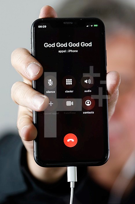 Image on a smartphone. Call to God. France.