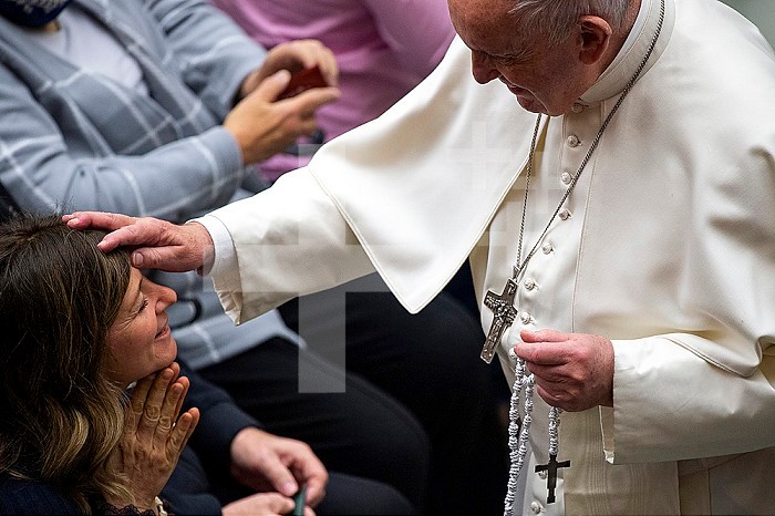 Pope Francis blessing a faithful during his weekly general audience in Paul VI hall at the Vatican.