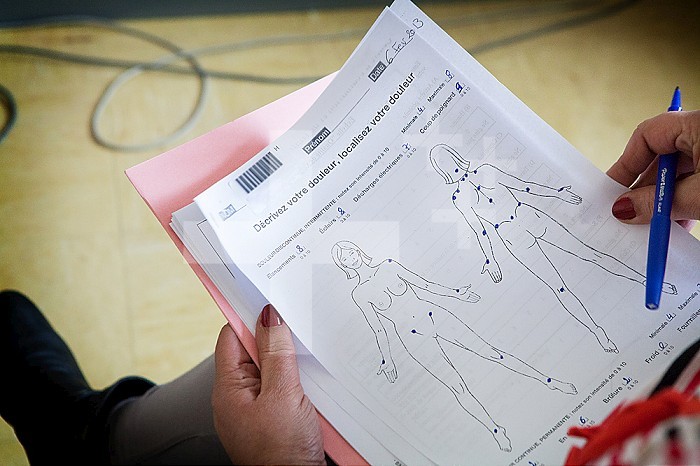 A patient fills out a form to assess and target chronic pain.