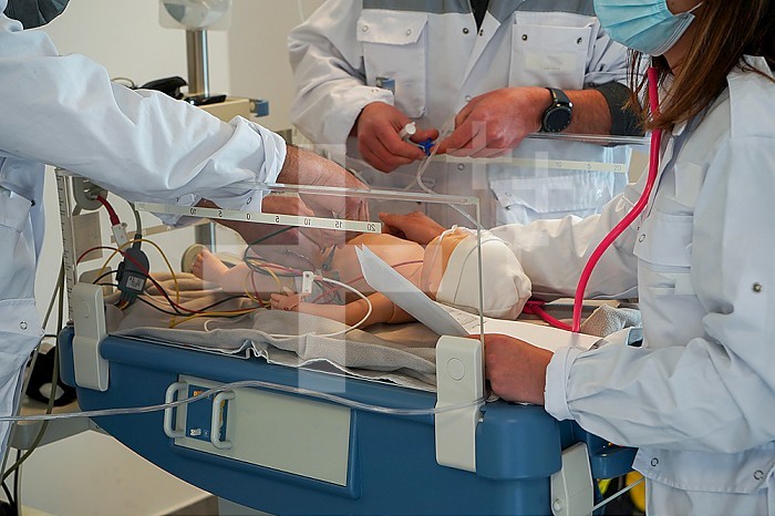Newborn dummy emergency care training. Training at the CESU, Center for teaching emergency care at the Faculty of Medicine of Montpellier. Different healthcare professionals train in real emergency situations on a SimNewB newborn dummy. The newborn is cared for by an emergency doctor assisted by doctors from the SMUR.
