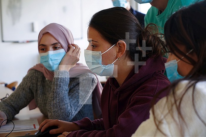Medical students during a computer simulation workshop. The software makes it possible to manage deliveries and emergency situations. A resuscitation student helps midwifery students.