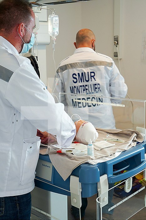 Newborn dummy emergency care training. Training at the CESU, Center for teaching emergency care at the Faculty of Medicine of Montpellier. Different healthcare professionals train in real emergency situations on a SimNewB newborn dummy. The newborn is cared for by an emergency doctor assisted by doctors from the SMUR.