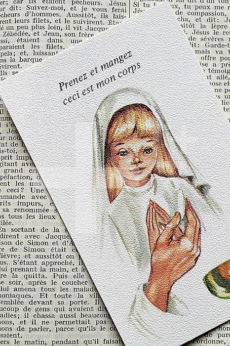 Open bible in french with religious image. First Communion. 