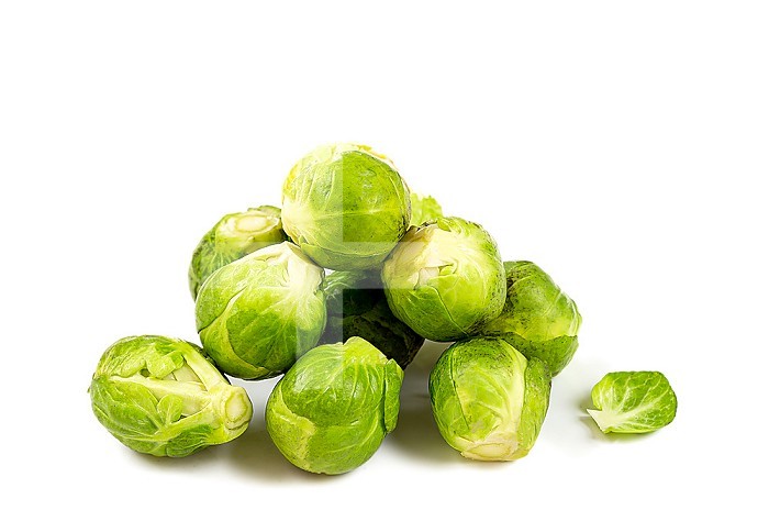 Brussels sprouts in a heap on a white background cut out