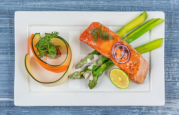 Minimalist presentation of a plate of salmon and vegetables- top view