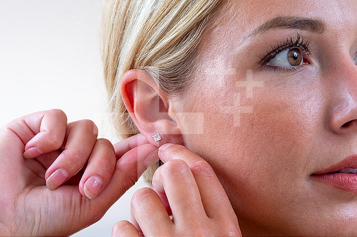 Woman hanging an earring