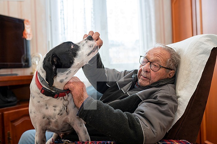 90 year old senior living with his dog.