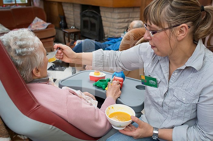 ADMR 62 - Home Help in Rural Areas, Pas de Calais. Veronique, Auxiliary of Social Life (AVS) intervenes in the home of Mr. and Mrs. B., severely handicapped by Alzheimer´s disease. Veronique must help him with all the daily tasks. Carer giving a bowl of soup to a dependent elderly person.
