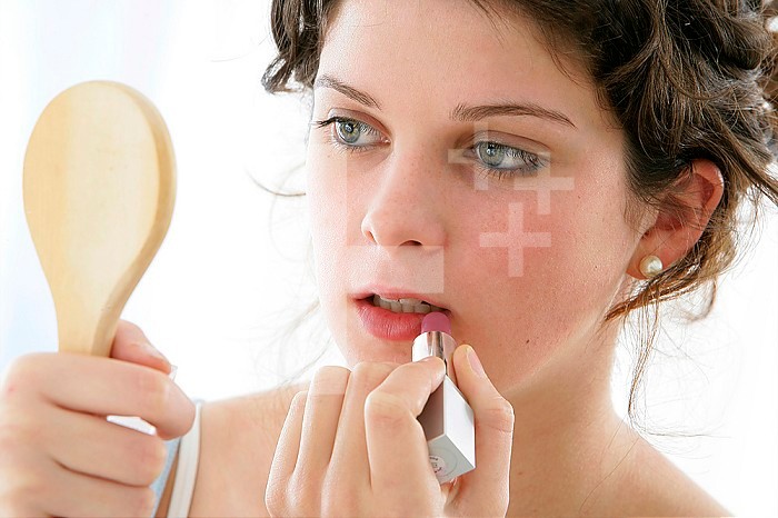 ADOLESCENT PUTTING ON MAKE-UP