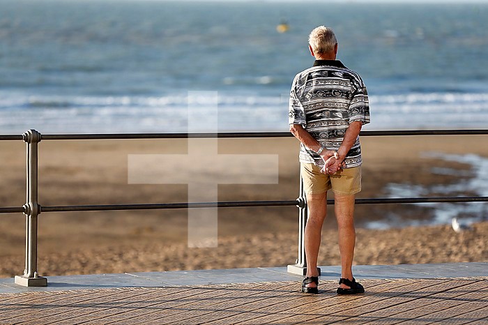 Retired man watching the sea.
