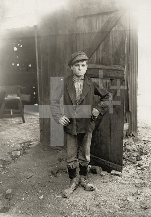 HINE: CHILD LABORER, 1908. /nA young worker waiting for the night shift at a glassworks factory in Indiana. Photograph by Lewis Hine, 1908.
